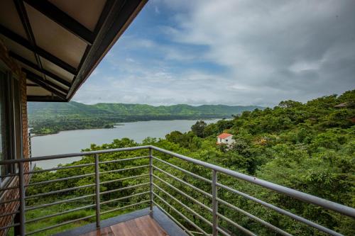 a balcony with a view of a river at Bougain Villa Resort Park By Dream Villas in Pune
