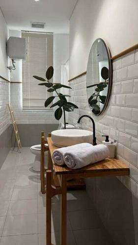 a bathroom with a sink and a mirror and a toilet at Rumah Lawani in Bandung
