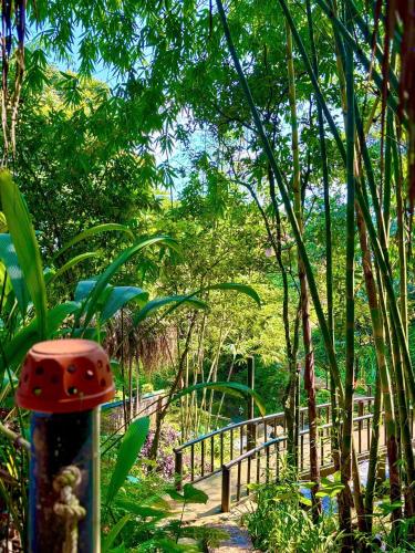 a garden with a fence and a red mushroom at Pu Luong Jungle Lodge in Pu Luong