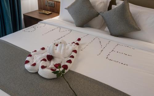 two towel animals sitting on top of a bed at Okash City Boutique Hotel in Nairobi