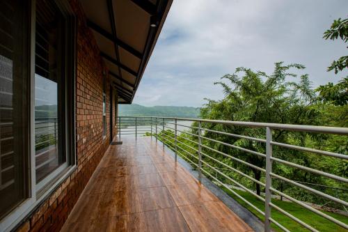a balcony of a house with a view at Bougain Villa Resort Park By Dream Villas in Pune