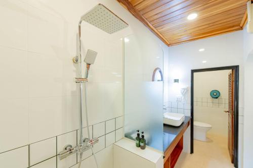 a bathroom with a shower with a glass door at Merry Riverside Hotel in Luang Prabang