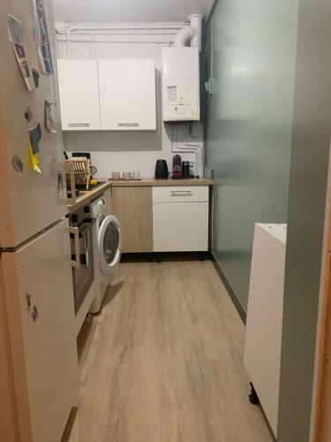 a kitchen with a refrigerator and a washing machine at Laurence in Paris