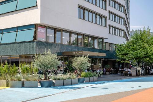 a building with people sitting outside of it at The Yarn in Horgen