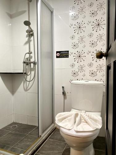 a bathroom with a toilet and a shower with snowflakes on the wall at Sunray Beach Hotel Patong in Patong Beach