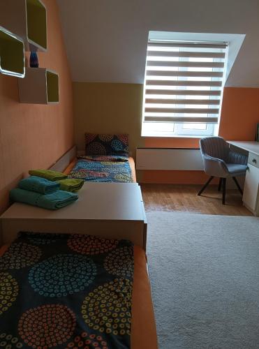 a bedroom with two beds and a window at Apartment Ventuno 21 in Sliven