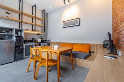a kitchen and living room with a wooden table and chairs at Feels Like Home Villa in Keramas