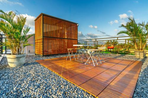 a wooden deck with a table and chairs on it at Feels Like Home Villa in Keramas