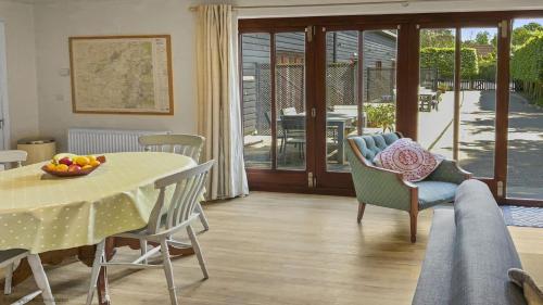 a living room with a table and chairs and a dining room at Whitedown in Alton