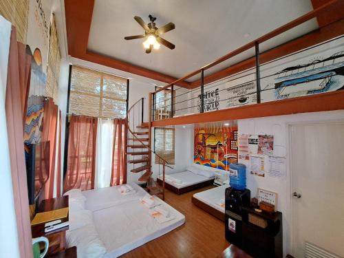 a room with a bed and a staircase in it at The Bistro House - Loft Unit - Vigan in Vigan