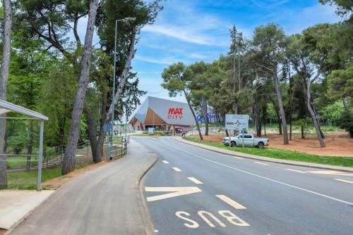 an empty road with a car parked on the side of the road at Skyline Apartment in Veruda