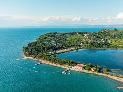 an aerial view of a small island in the water at Hotel Laguna - Terme Krka in Strunjan