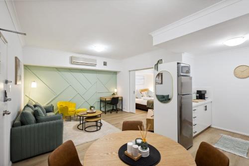 a living room with a couch and a table at Sleek Northbridge Getaway in Perth
