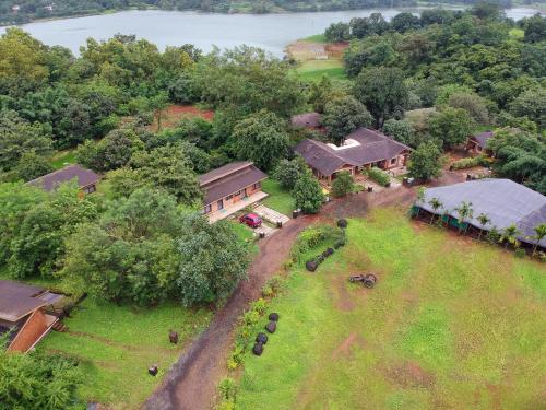 an aerial view of a house with a field and trees at Bougain Villa Resort Park By Dream Villas in Pune