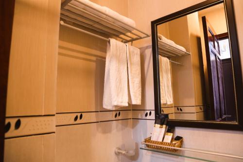 a bathroom with a mirror and a white towel at MK Two Hotel in My Tho