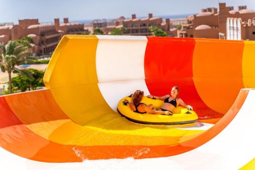 two people riding on a ride in a roller coaster at Akassia Swiss Resort in Quseir