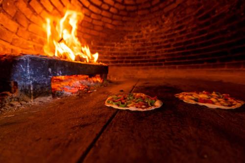 two pizzas are cooking in a brick oven at Akassia Swiss Resort in Quseir