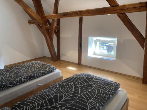 an attic room with two beds and a window at Ferienwohnung Zweinig05 in Zweinig