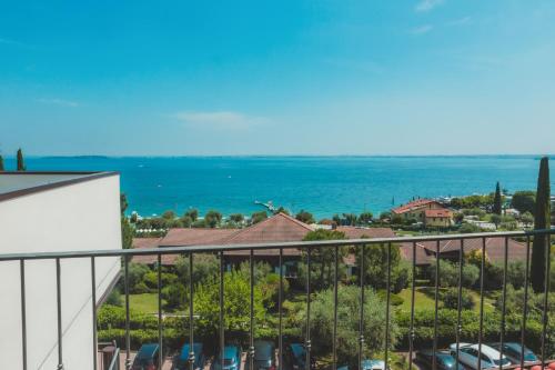 a view of the ocean from the balcony of a building at AHG Riva Del Sole Hotel - Adults Only in Moniga