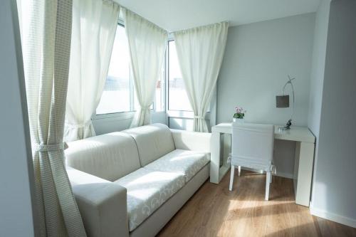 a living room with a white couch and a window at Solmar Lodge in Ponta Delgada