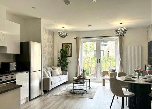 a kitchen and living room with a couch and a table at Homi Host-Apricot House in Birmingham