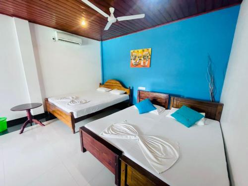 Postel nebo postele na pokoji v ubytování Hotel Sanda Diya - Dambulla