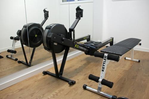 a gym with a treadmill and a simulator at Secret Paradise in Attalens