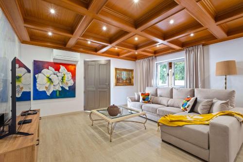 a living room with a couch and a tv at Villa Rosa Estoril Retreat by Portugal Portfolio in Estoril