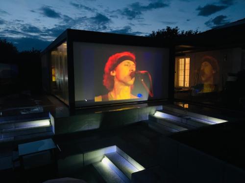 a television screen with a woman singing into a microphone at Secret Paradise in Attalens