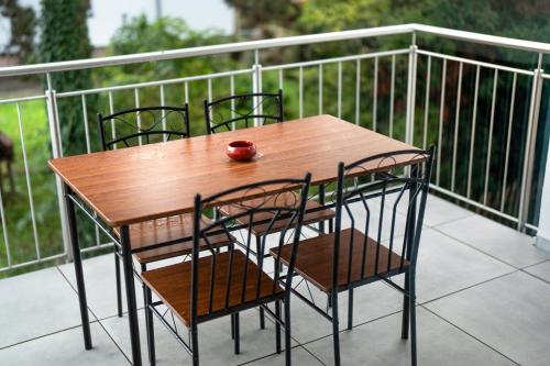 a wooden table and chairs on a balcony at White House Apartments in Kappel-Grafenhausen