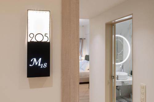a bathroom with a sign on the wall next to a mirror at M18 Studios Monastiraki Gems in Athens