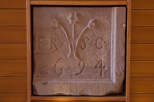 a wooden box with a carving of a flower on it at Logis Hôtel de la Tour in Ribeauvillé