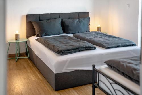 a bedroom with a large bed with two pillows at White House Apartments in Kappel-Grafenhausen