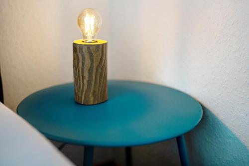 a blue table with a light bulb on top of it at White House Apartments in Kappel-Grafenhausen