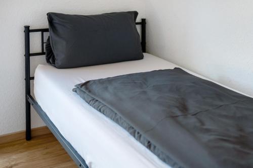 a bed with a pillow on top of it at White House Apartments in Kappel-Grafenhausen