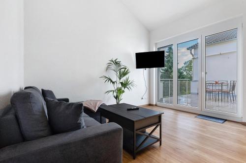 a living room with a couch and a table at White House Apartments in Kappel-Grafenhausen