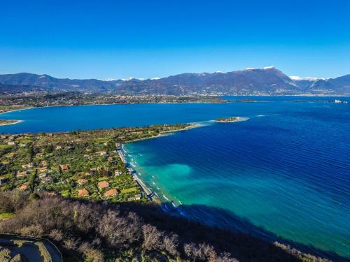 an aerial view of a beach and the ocean at AHG Donna Silvia Wellness Hotel in Manerba del Garda
