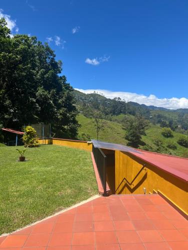 a patio with a view of a field of grass at Ecoresort Gran Azul in Salento