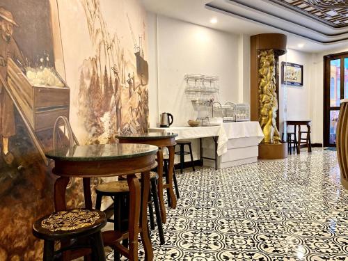a restaurant with a table and chairs in a room at Sunray Beach Hotel Patong in Patong Beach