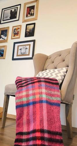 a blanket sitting on a stool next to a couch at HUUT in Zlatibor