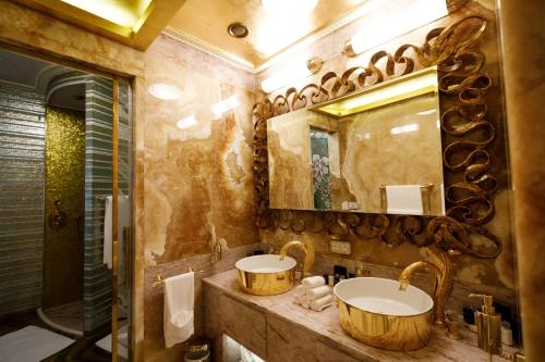 a bathroom with two sinks and a mirror at King's Resort - casino and hotels in Rozvadov