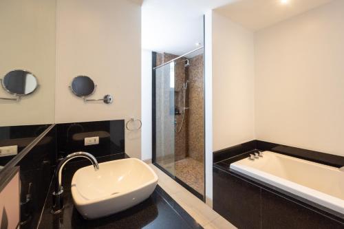 a bathroom with a sink and a bath tub at Selina Serenity Rawai Phuket in Rawai Beach