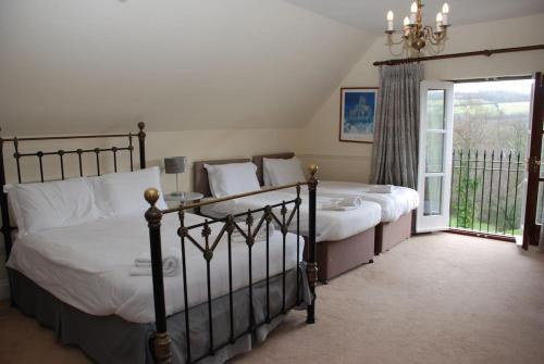 a bedroom with two beds and a large window at Woodbank in Caerleon