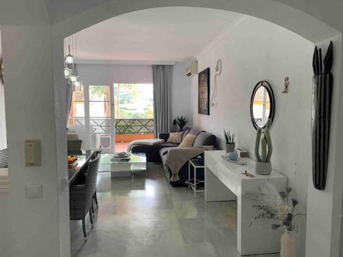 a living room with a couch and a table at Oasis Golf Apartment in Sitio de Calahonda