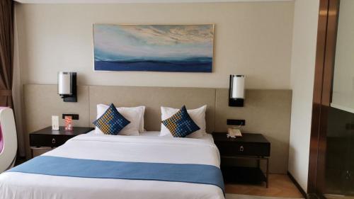 a bedroom with a large bed with two night stands at Ocean Delight Boutique Hotel 海悦精品酒店 in Sihanoukville