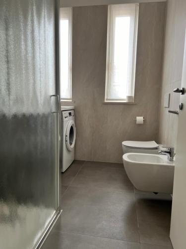 a bathroom with a sink and a washing machine at Le Piazzette 2 in Schio