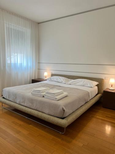 a bedroom with a bed with two towels on it at Le Piazzette 2 in Schio