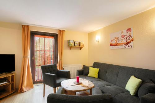 a living room with a couch and a table at Ferienhaus Sonnenhof in Blankenburg