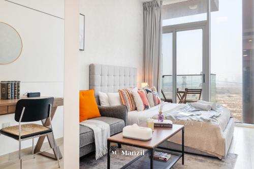 a living room with a couch and a table at Manzil - Stylish living in JVC, City Views and Pool in Dubai