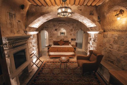a bedroom with a bed and a fireplace at Harem Suites Cappadocia in Uchisar